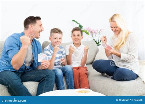 Happy Family Playing Card Game on Living Room Sofa at Home and Having ...