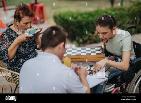 Family bonding over a fun card game outdoors together Stock Photo - Alamy