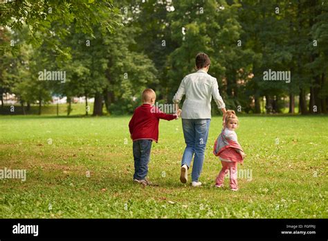 happy family playing together outdoor in park Stock Photo - Alamy