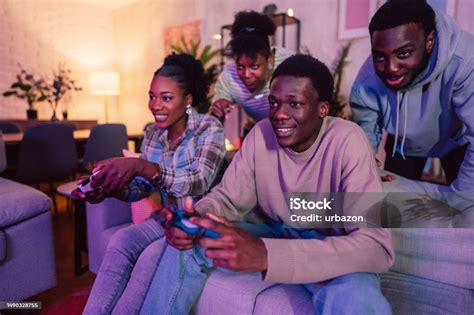 Black Family Playing Video Games Together In The Living Room Stock ...