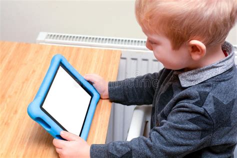 Child Using a Tablet Computer To Learn and Play Games, Model is Young ...