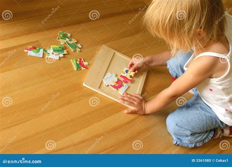Child solving puzzle stock photo. Image of home, assignment - 3361080