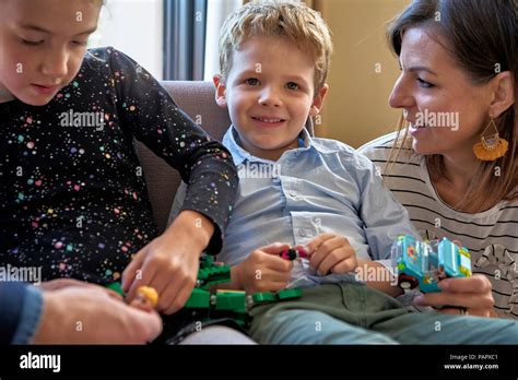 Happy family playing together at home Stock Photo - Alamy