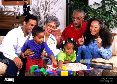 Three generation black african american family playing board games at ...