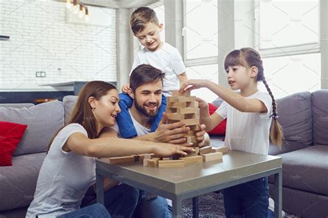 Happy family playing board games at home stock photo containing family ...