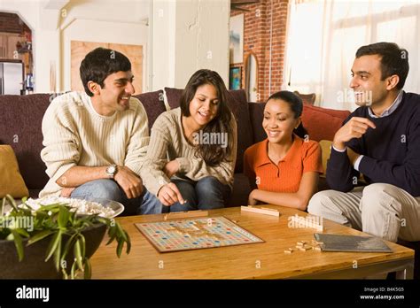 Multi-ethnic family playing board game Stock Photo - Alamy