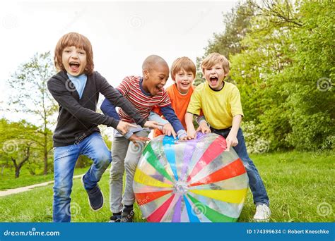 Children Laugh at the Game with the Colorful Ball Stock Photo - Image ...