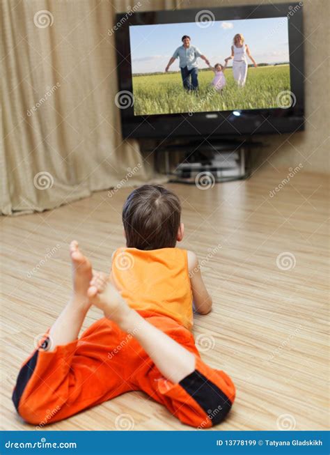 Child watching TV stock image. Image of laying, domestic - 13778199