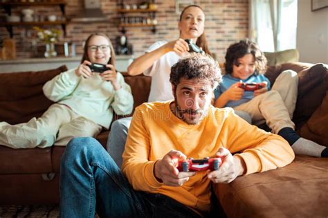 Young Family Playing Video Games Together in the Living Room on a ...