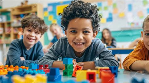 Kids playing educational games with building blocks and puzzles in a ...