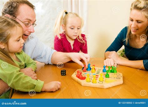 Family Playing a Board Game Stock Photo - Image of winning, game: 12310002