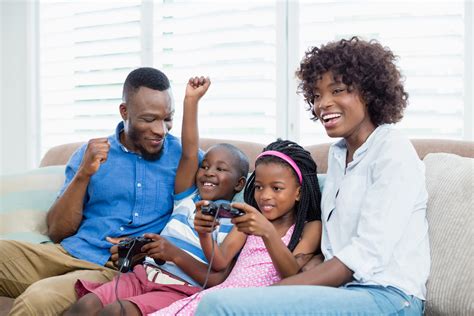 Happy family playing video game - LearningWorks for Kids