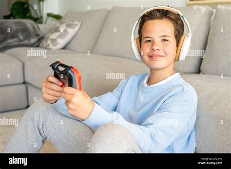 Shot of an adorable young boy wearing headphones while playing video ...