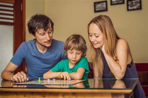 Happy Family Playing Board Game at Home Stock Photo - Image of floor ...