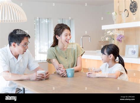 Parent and child talking in the dining room Stock Photo - Alamy
