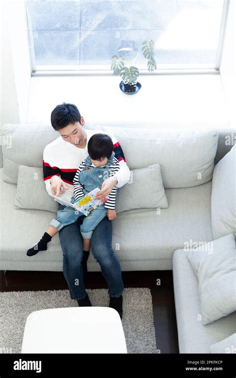 Parent and Child Reading Picture Book Stock Photo - Alamy