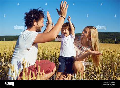 A happy family is enjoying fun with a child outdoors Stock Photo - Alamy