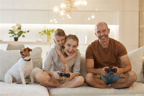 Premium Photo | Cute portrait of happy modern family playing video ...