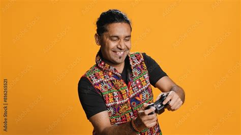 Happy gamer celebrating after winning game on gaming console, studio ...