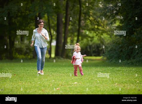 happy family playing together outdoor in park Stock Photo - Alamy