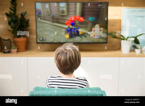 CHILD PLAYING VIDEO GAME Stock Photo - Alamy