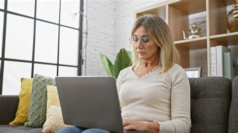 Mature Caucasian Woman Using Laptop in Cozy Living Room Stock Image ...